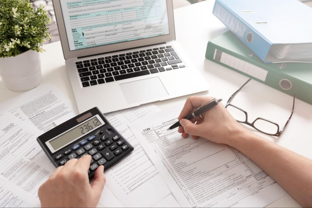 Person filing taxes at their desk.
