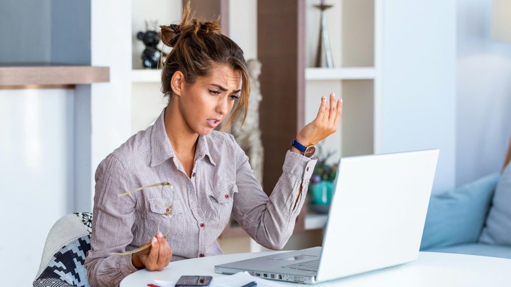 frustrated woman sitting at laptop