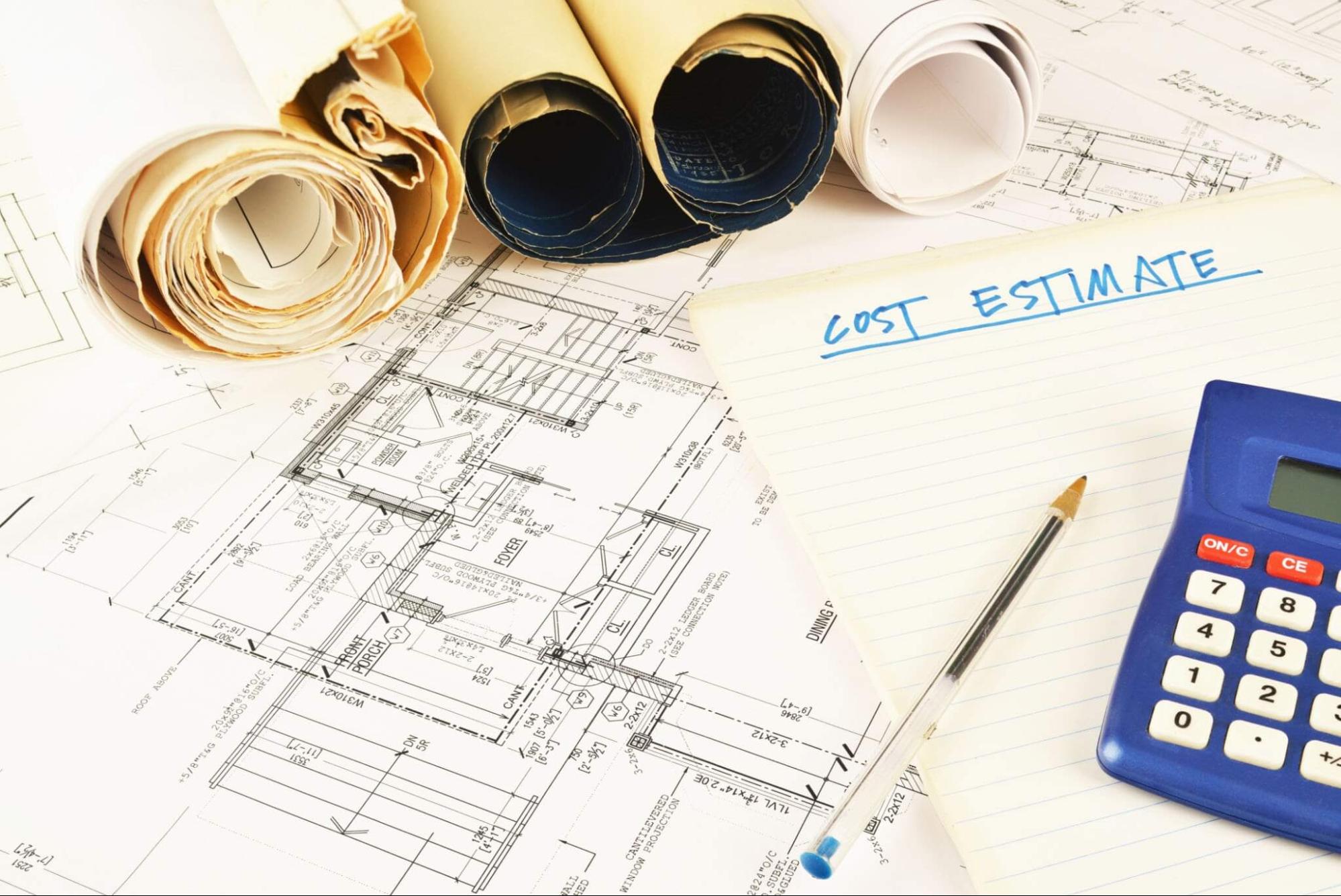 unrolled architectural blueprints and technical drawing with blue calculator