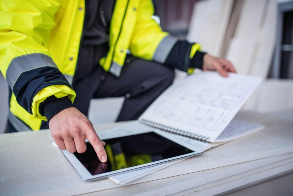 construction site manager using a digital tablet to inspect building progress